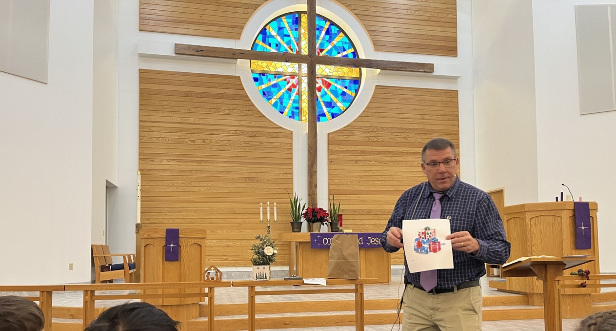 man holding art in church